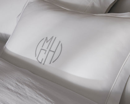 White Bergamo pillows with a tailored trim, close-up.