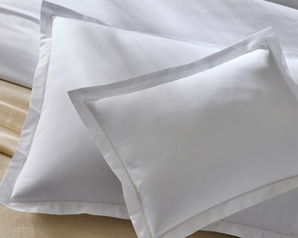 Gray Luca sheeting with a hemstitch trim, close-up.