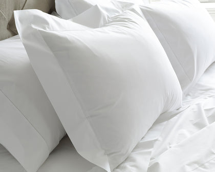 White Sierra pillowcase with an embroidered monogram, close-up.