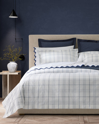 White and blue August Plaid bedding with a scalloped navy trim.