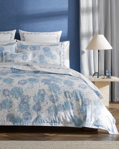 Blue Chrysanthemum print bedding with embroidered vine trim shams.