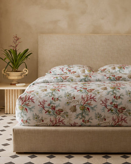 Del Tesoro coral and shell print bedding in red and green.