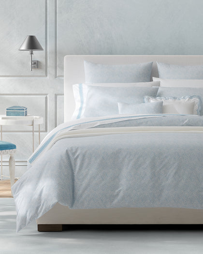 Pale blue Duma Diamond print bedding styled on a bed.