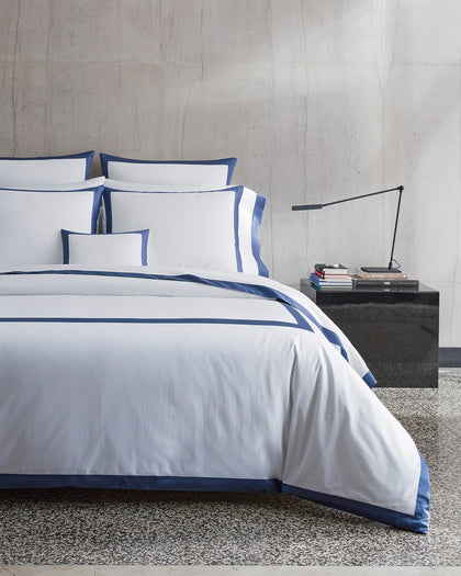 White Emory bedding with a navy tailored border.