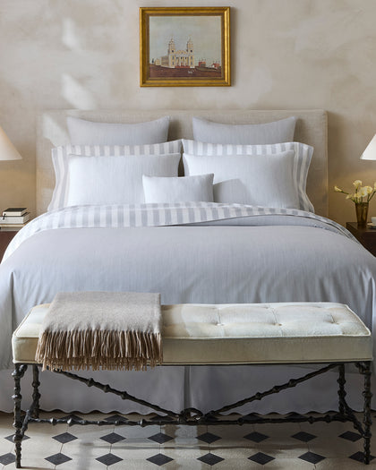 Lana grey striped bedding styled on a bed