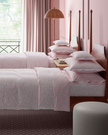 Pink Margot vine-print bedding styled on twin beds.