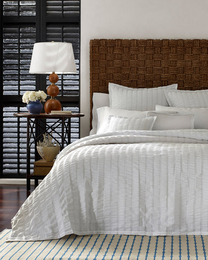 White seersucker-textured Panama bedding styled against a headboard.