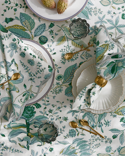 Green Pomegranate botanical print tablecloth and napkins, set with Greek key china and gold flatware from above.
