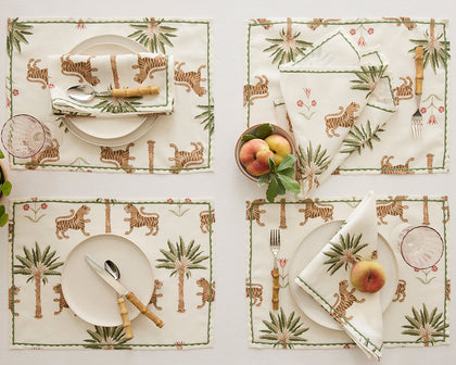 Tiger Palm placemats and napkins with tiger and palm tree print set for four with fresh peaches.
