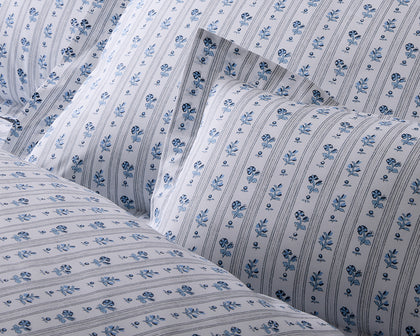 Blue and white Cabanon Stripe floral bedding.