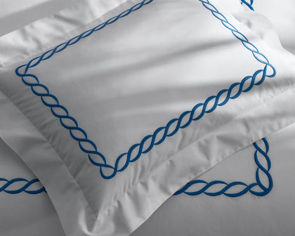 White Classic Chain pillow with bold blue chain-link embroidered trim.