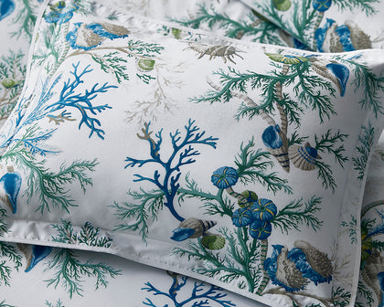 Blue Del Tesoro coral and shell print pillow.