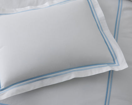 White Essex pillow sham with a double blue stitched border.