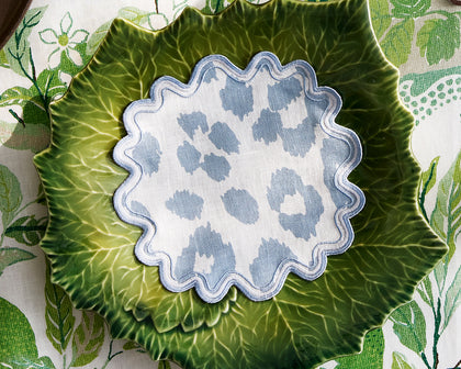 Blue Iconic Leopard print scalloped coaster on a green cabbage-shaped plate.