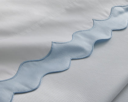 White Lorelei scalloped bedding edge with a light blue trim.