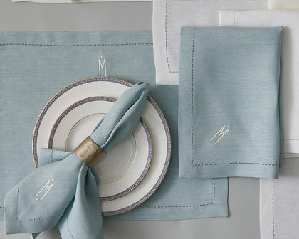 Blue Valentina Hemstitch placemat and monogrammed napkin with Greek key china plates.