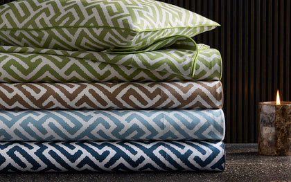 Gabriel fretwork print bedding stacked in green, brown, blue, and navy.