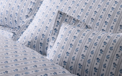 Blue and white Cabanon Stripe floral bedding.