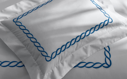 White Classic Chain pillow with bold blue chain-link embroidered trim.