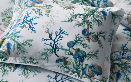 Blue Del Tesoro coral and shell print pillow.