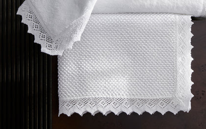 Ellis white lace-trim towels stacked
