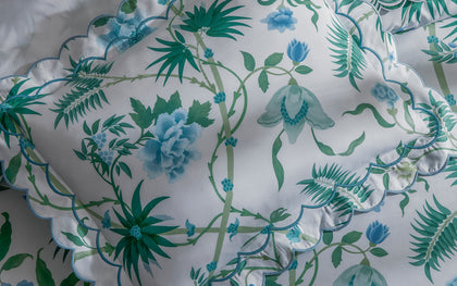 White Palmyra floral-print pillow sham with blue and green vines and scalloped trim.