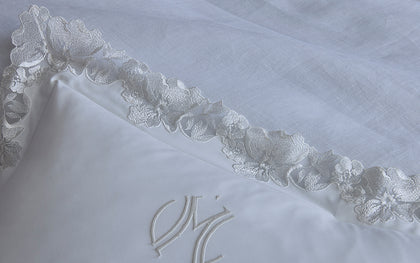 White Virginia pillow with floral lace trim and monogram.