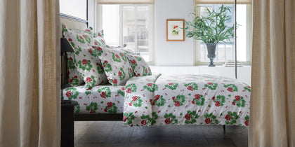 White Geranium print bedding with a scalloped edge, styled on a canopy bed.