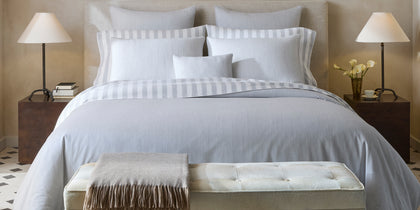 Lana grey striped bedding styled on a bed