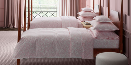 Pink Margot vine-print bedding styled on twin beds in a pink bedroom.