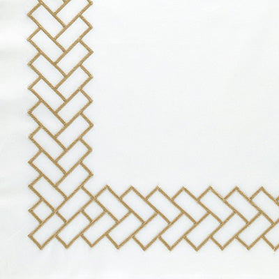 Close up of a napkin featuring a gold embroidered herringbone pattern along the border, featuring an L-shaped corner design.